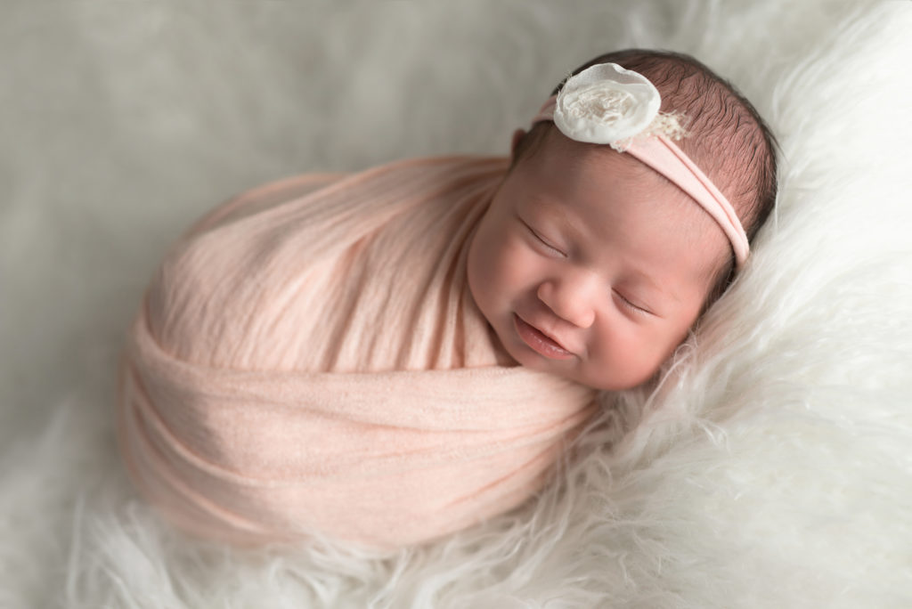 Pink Newborn Girl Sleeping in white fuzz