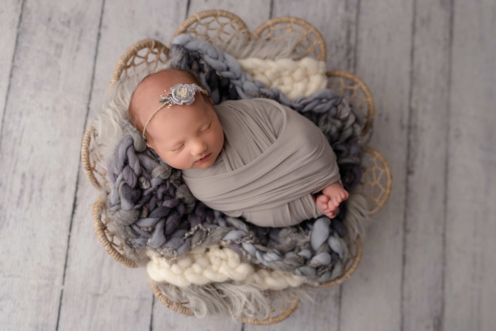 Dreamcatcher basket prop with newborn girl with gray layering in wrap