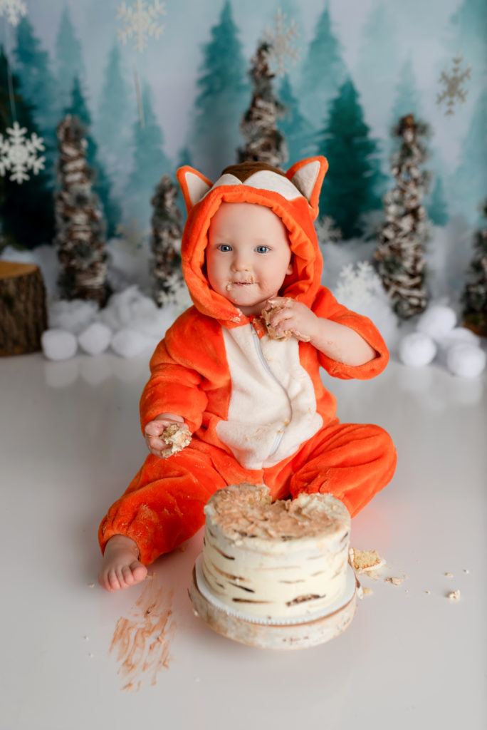 Happy Baby eating cake for smash studio winter onederland set