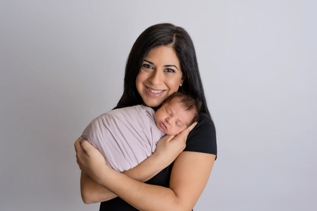 new mom with newborn girl in studio photography session in charlotte nc