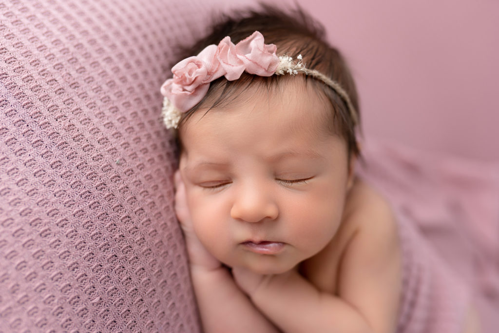 sleeping baby close up in pink newborn photo