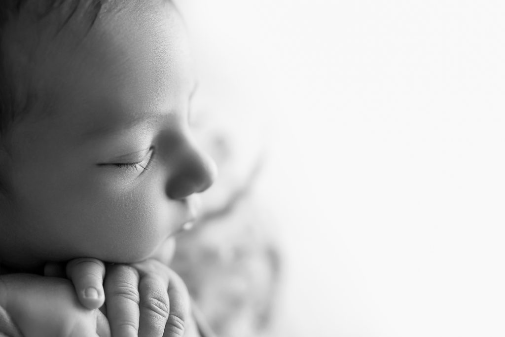 close up of eyelashes and profile of newborn face black and white