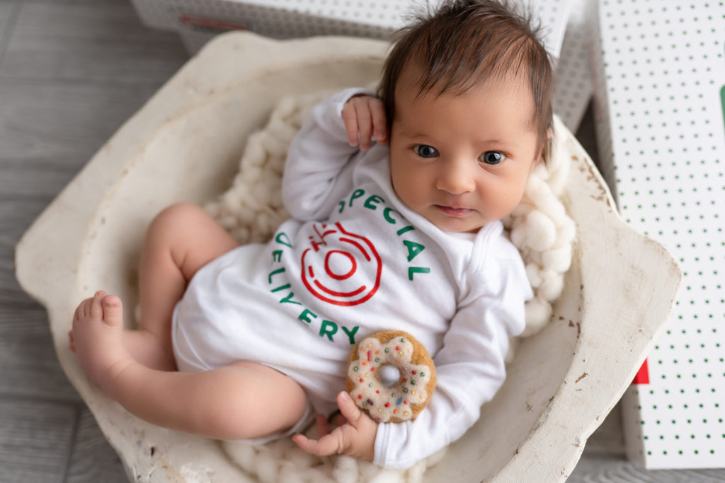 studio newborn photography posed with donut special delivery