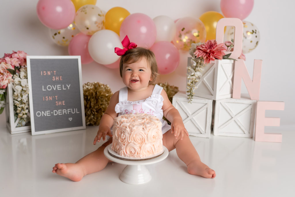 baby girl so excited for first cake smash in studio