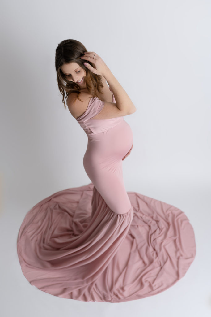 flowing maternity dress on glowing expectant mom in Waxhaw