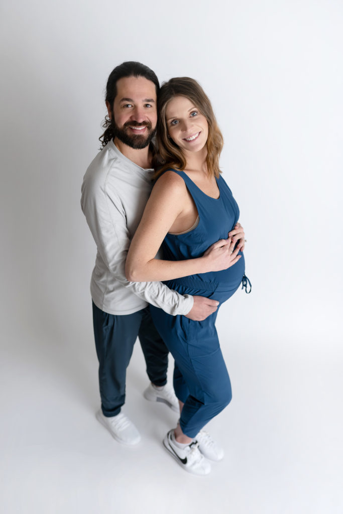 loving couple posed for maternity shoot in Charlotte studio