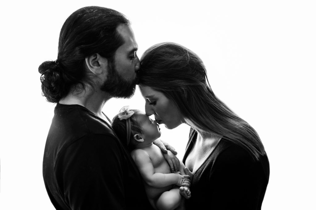new parents love newborn baby girl in Charlotte photography studio