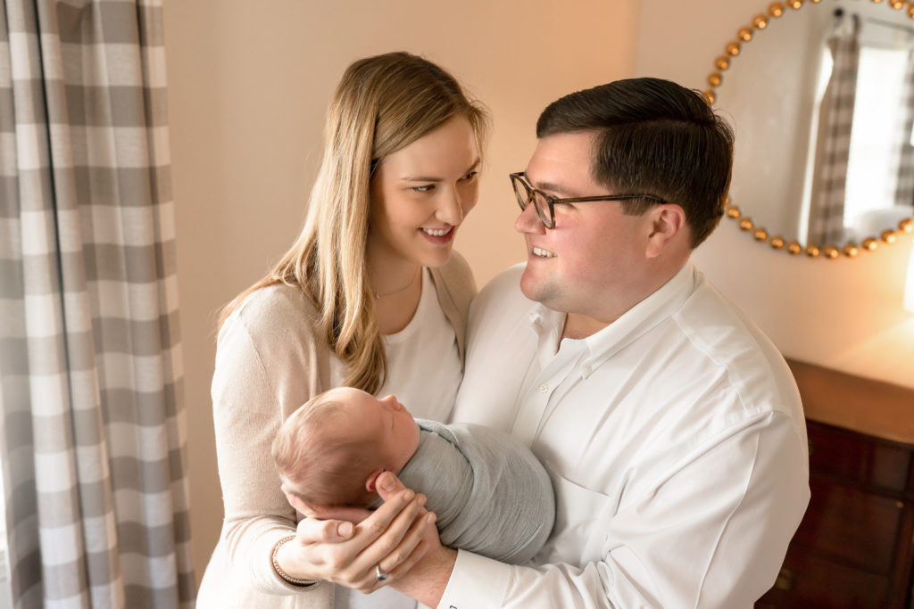 family baby together holding and smile white clothes