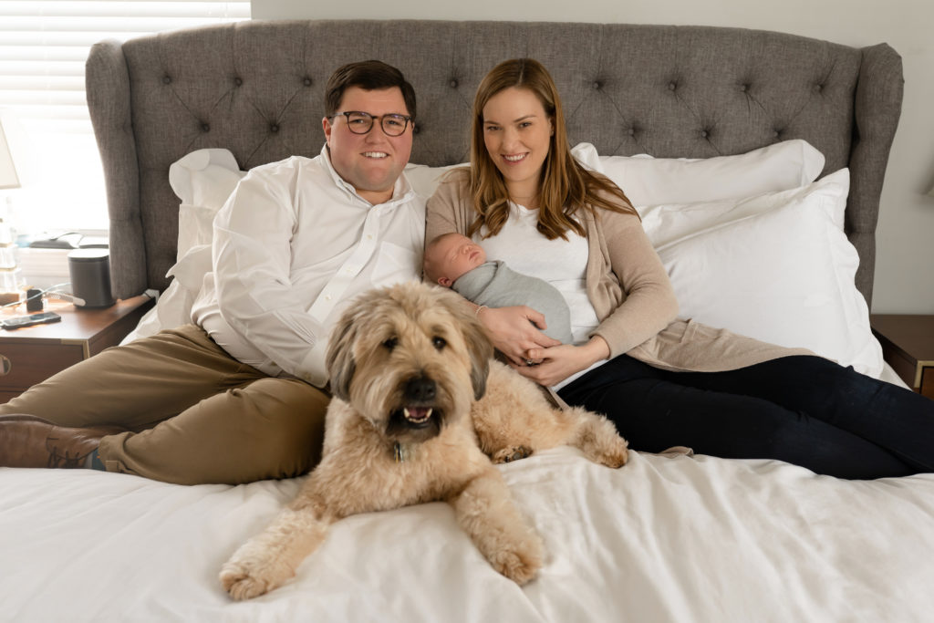 happy photograph entire family with dog on bed new baby boy