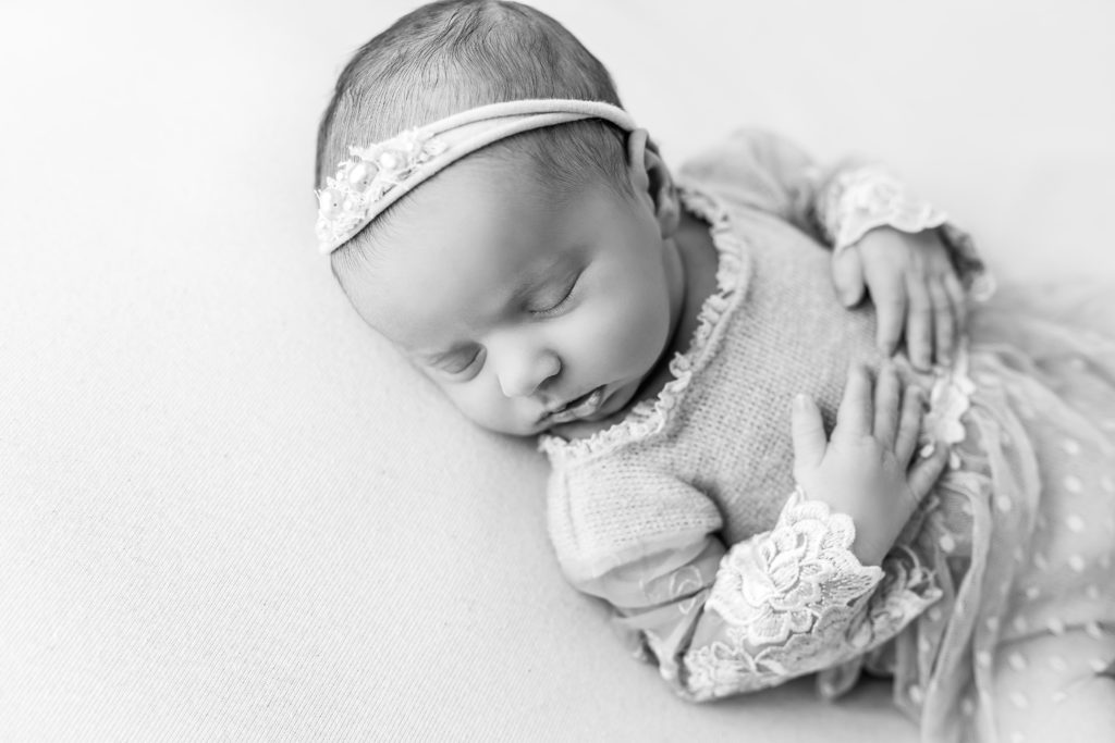 black and white newborn adorable baby sleeping folded hands