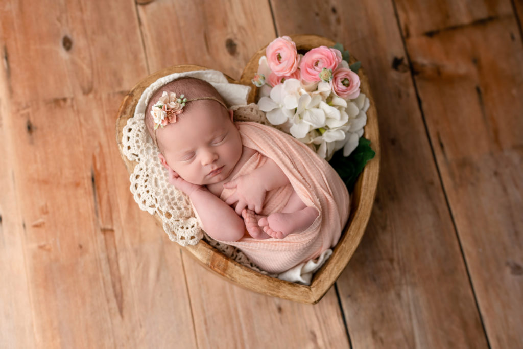 newborn baby adorable heart shaped basket with flowers sleeping photography
