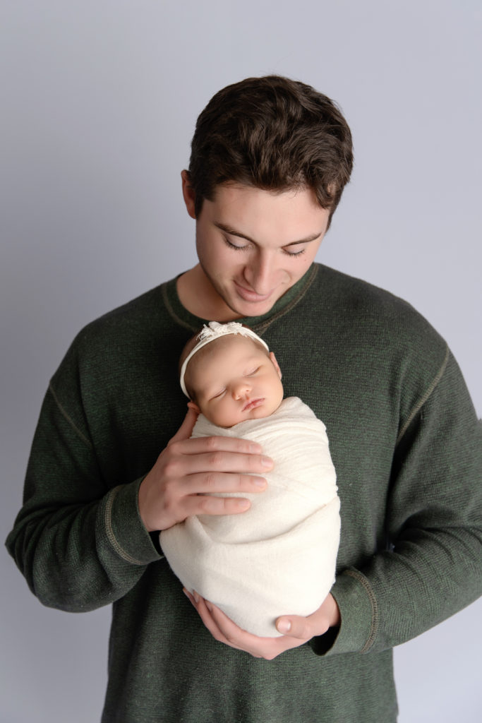 father holds newborn