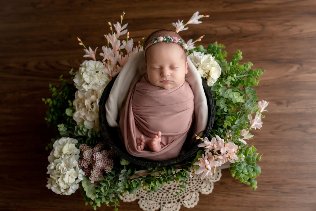 Baby girl in flower wreath.
