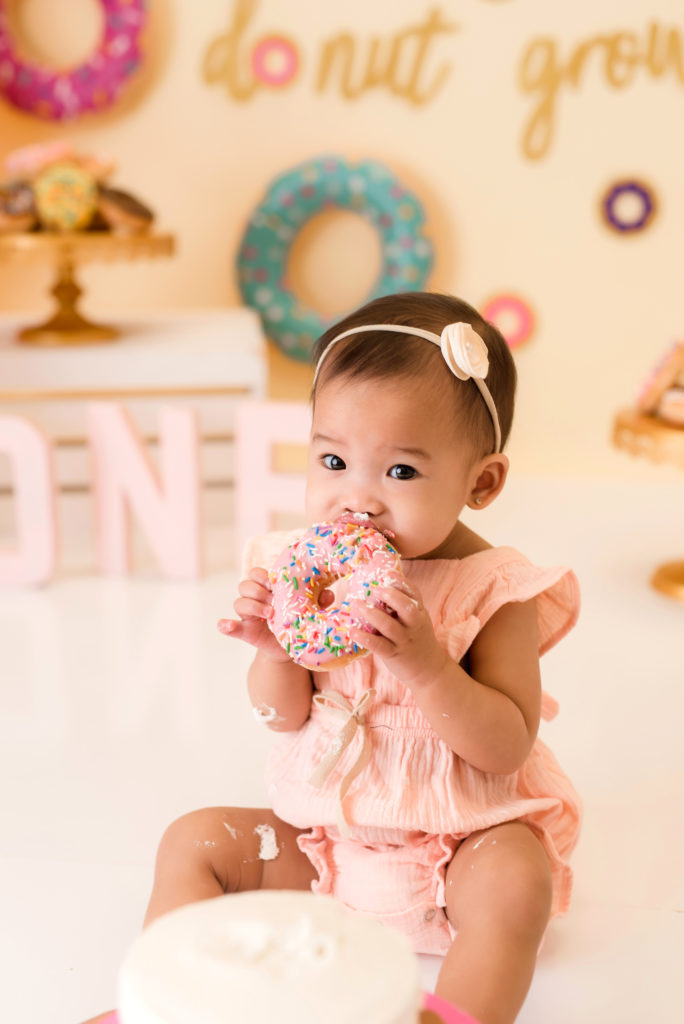 One year old eating a donut.