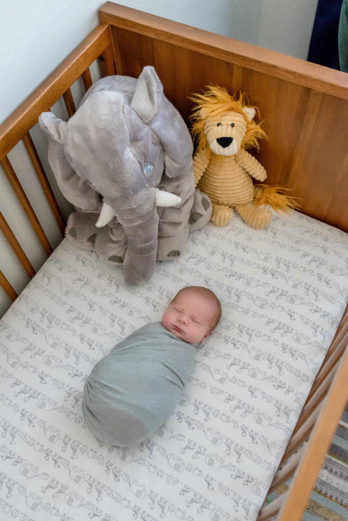 Newborn baby in crib.