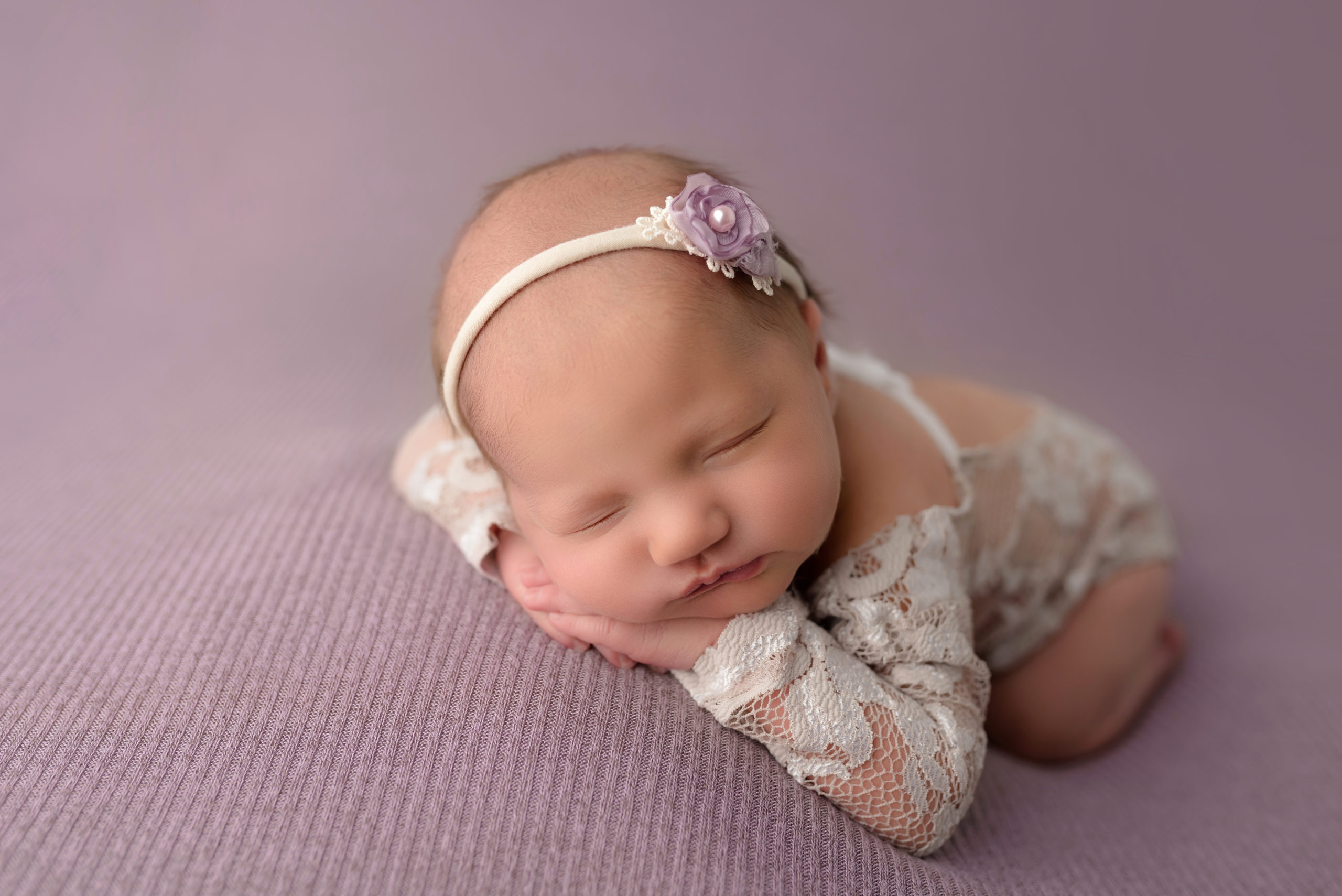 Baby Girl chin on hands facing forward in white lace outfit in indian trail photography studio