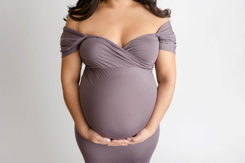 close up of belly in purple 
maternity dress
 