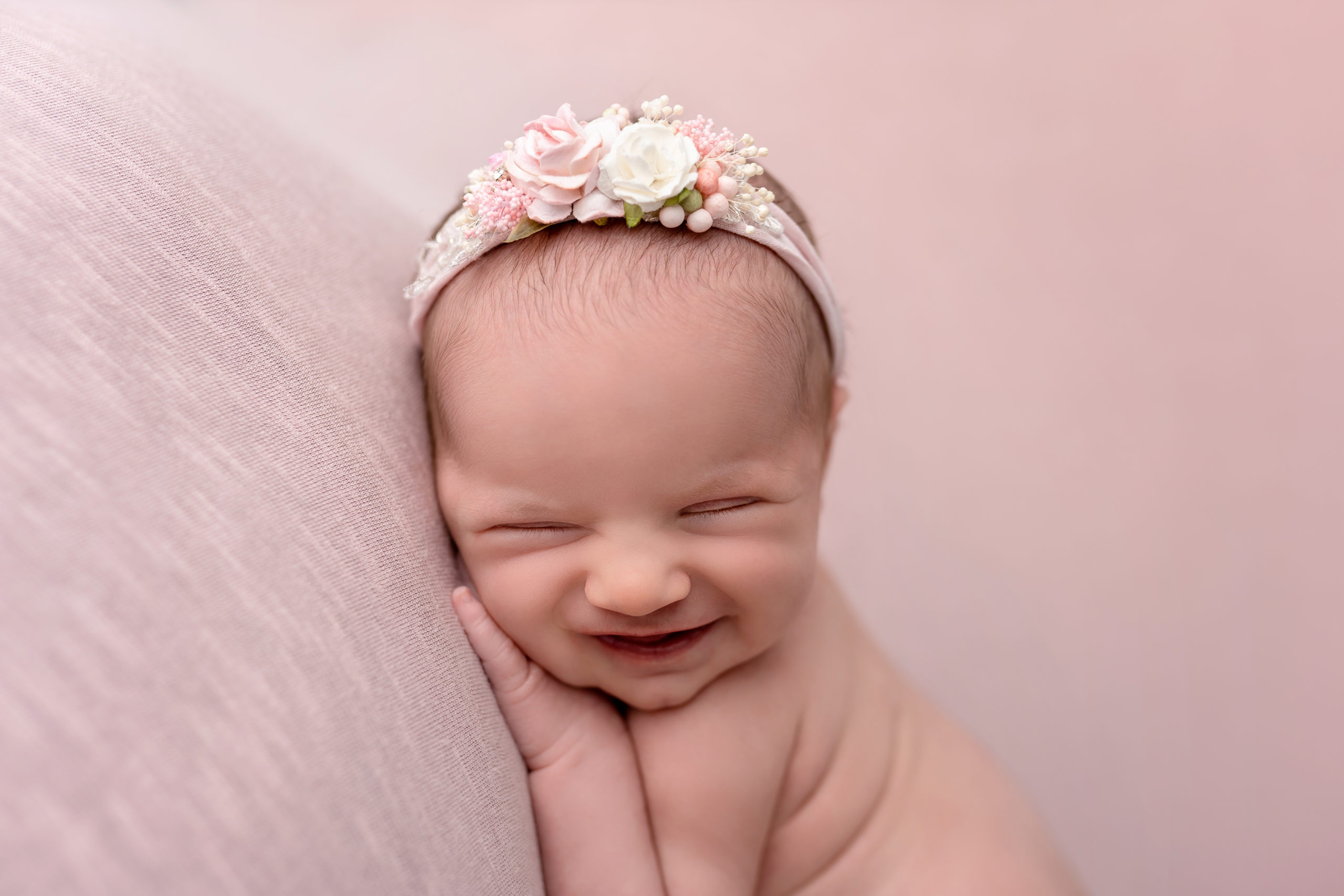 smiling baby pink pillow newborn happy white bow