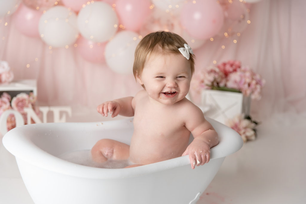 baby girl happy smiling in tub