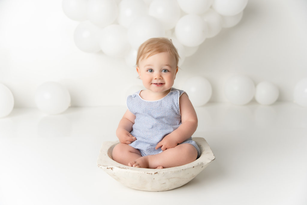 baby boy in blue posed in bowl