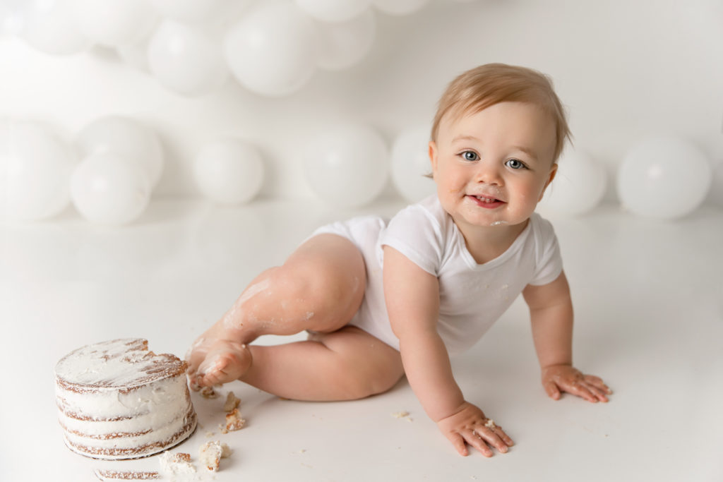 baby boy wearing white for cake smash