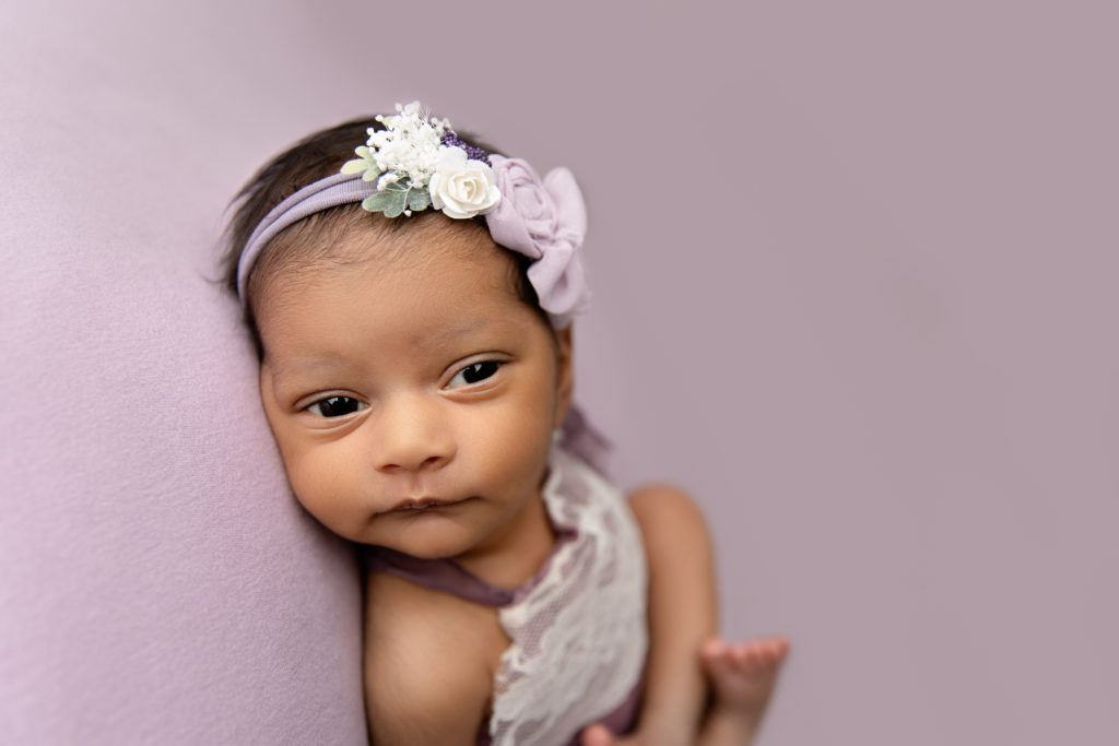 newborn girl in purple eyes open