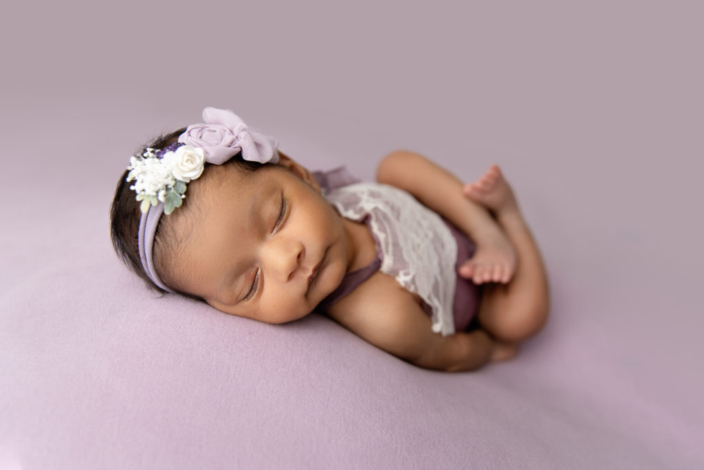 newborn girl in purple with headband