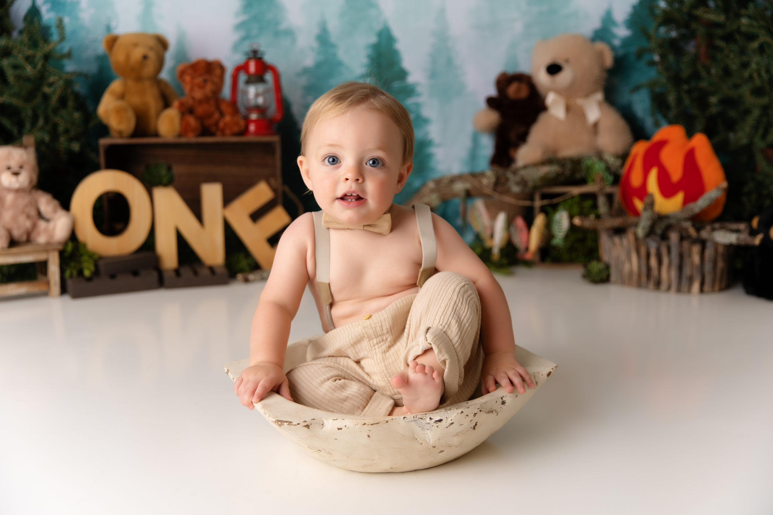 baby boy sits in bowl for woodland cake smash