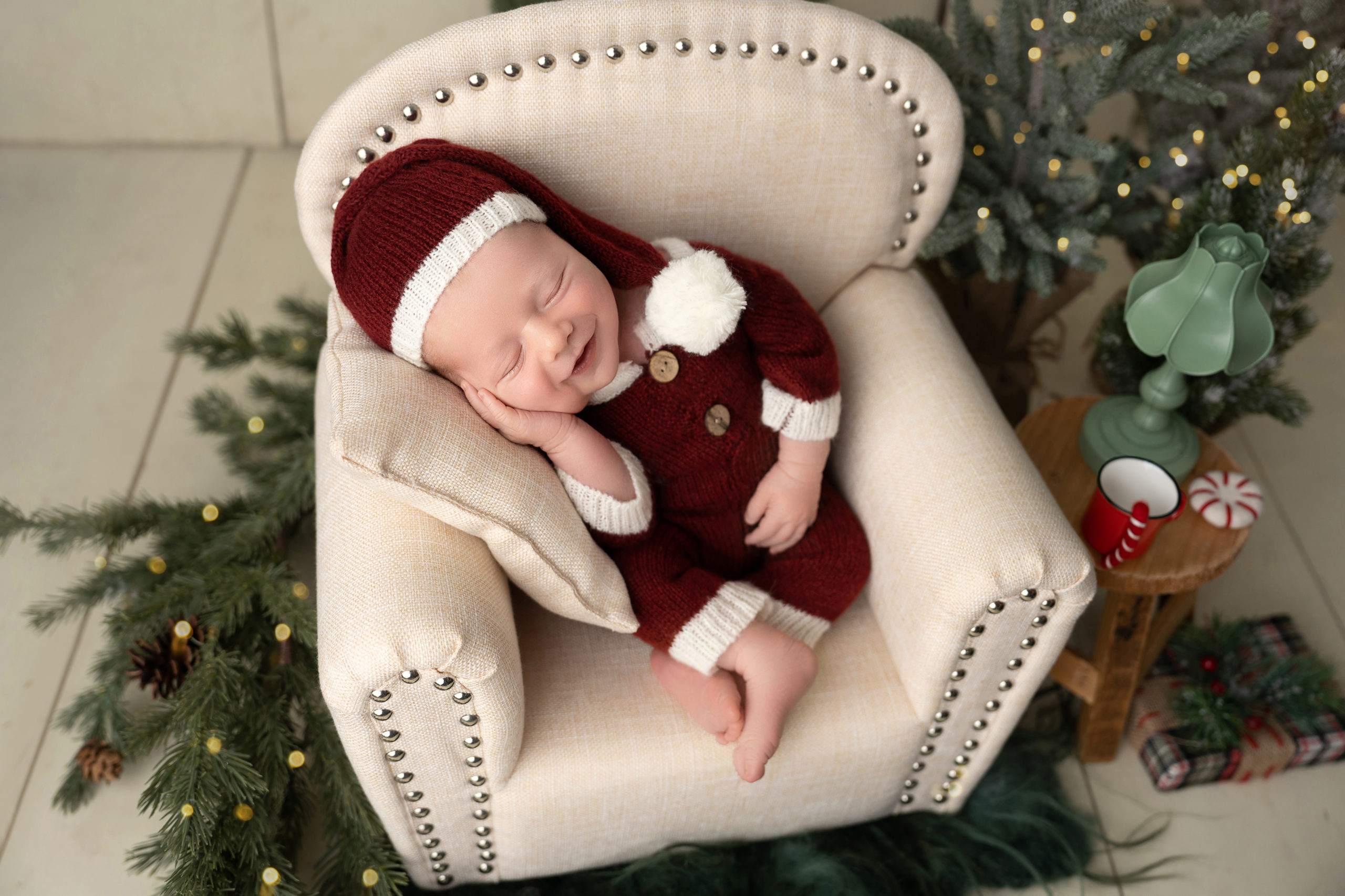 baby in armchair dressed as santa