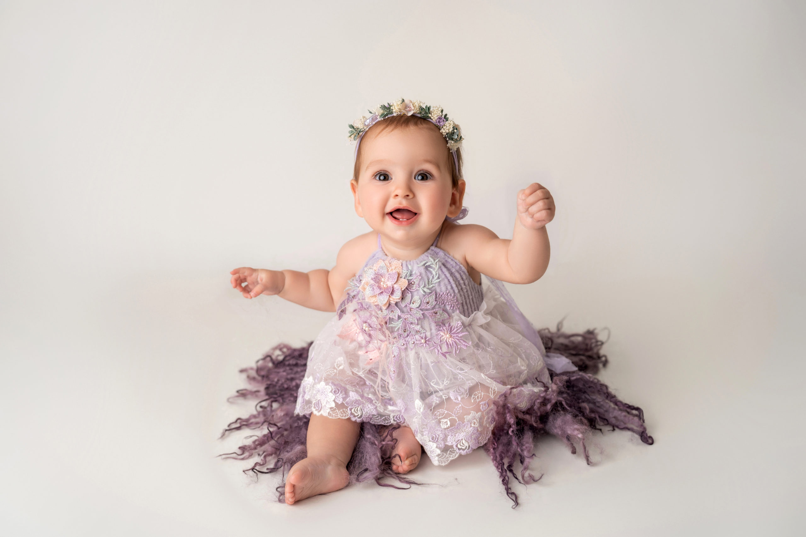 baby girl smiling on purple fur