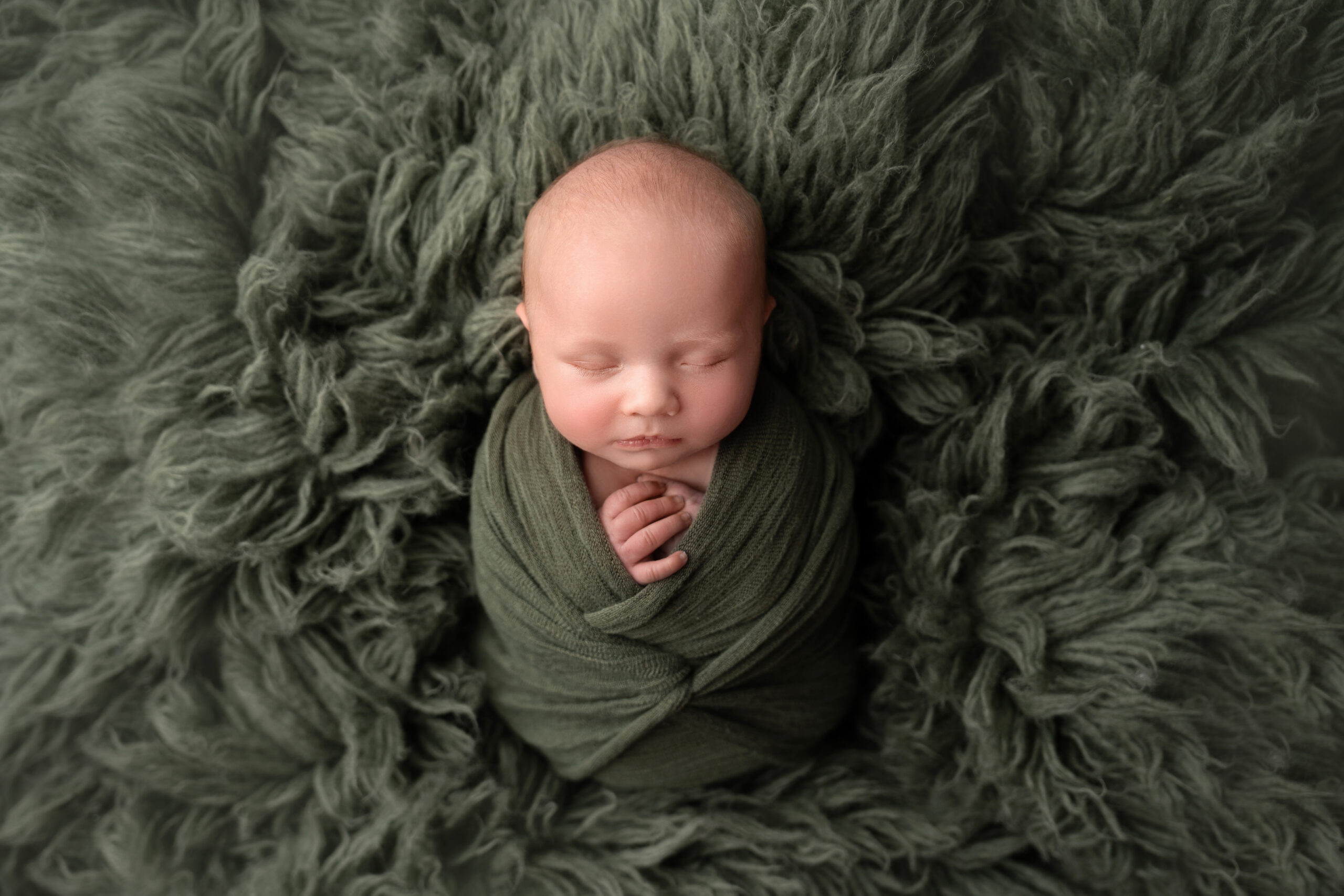 newborn baby boy in cozy photography session