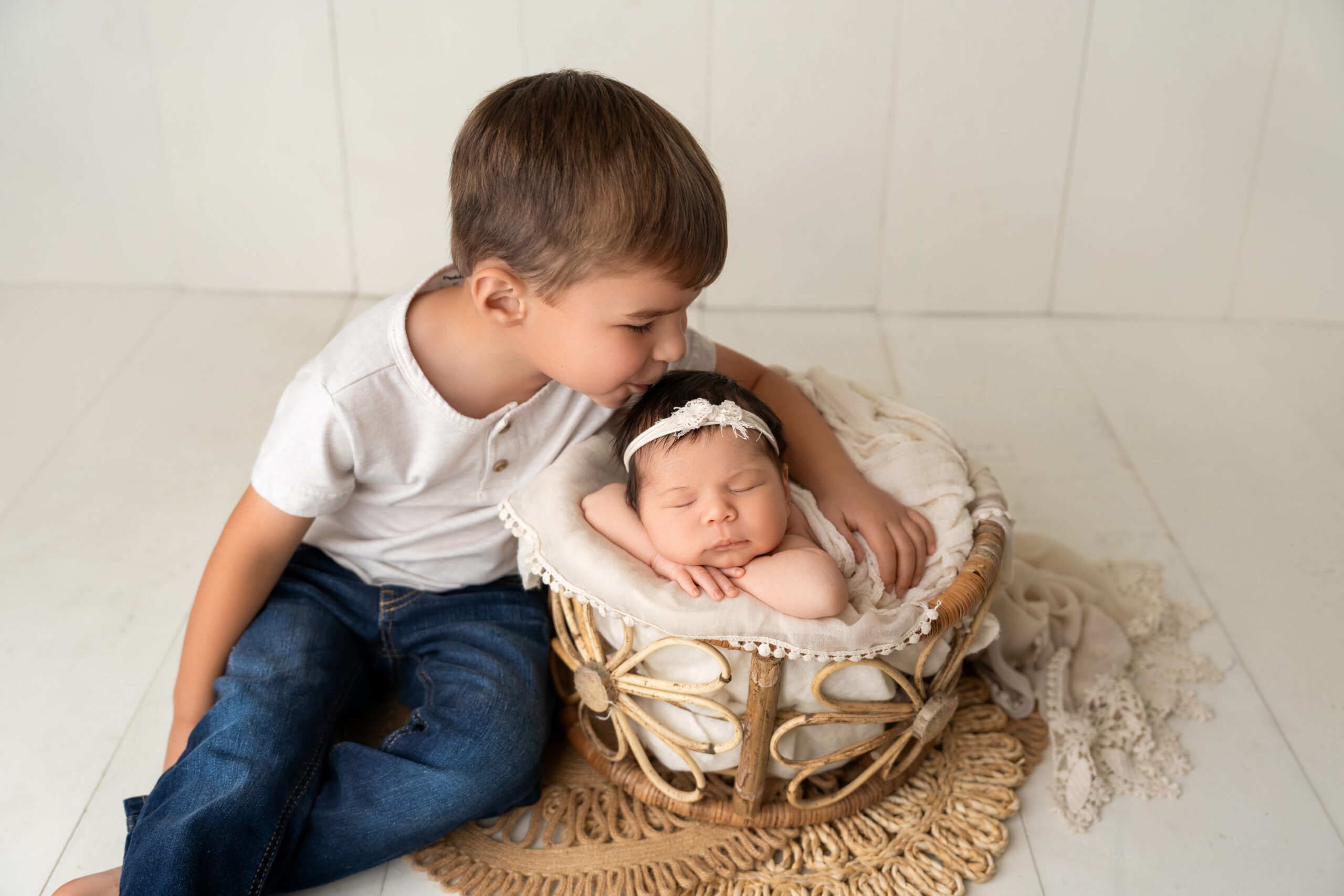 big brother kisses newborn little sister